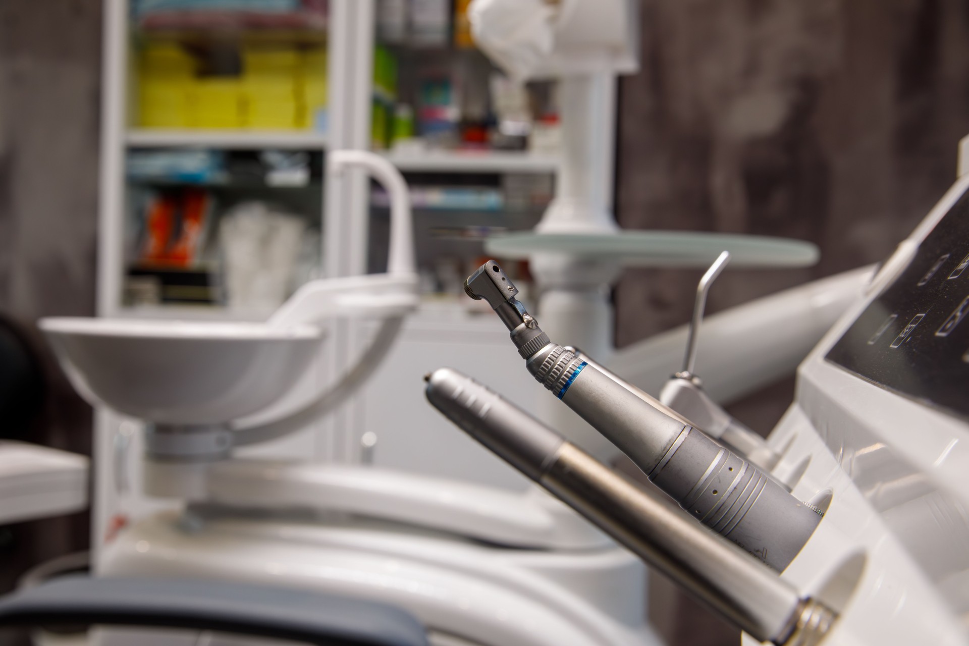 Dental instruments in focus with clinic background